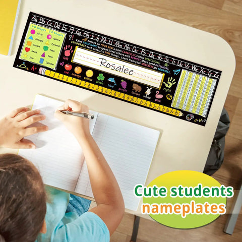 Student using Extra Large 17.3 By 5 Inch Self Adhesive Desk Name Tags For Classrooms, Multipurpose Manuscript Name Plates With Alphabet Letters And Class Rules, 24 Pack, Easy Peel And Stick, Durable Material For Student Desks on desk. Nameplate shows alphabets and class rules.