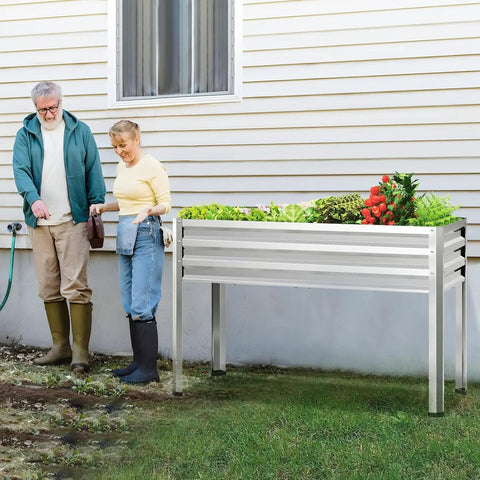 Two Pack Galvanized Raised Garden Bed With Legs For Easy No Bending Gardening filled with vegetables, on backyard patio.