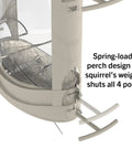 Close-up of X-1 Squirrel-Proof Bird Feeder with four feeding ports and spring-loaded perch design, transparent body.