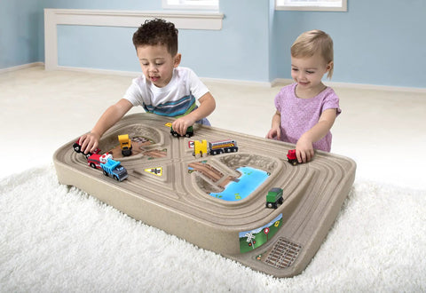 Children playing with On The Go Kid Friendly Race Track Table With 2-Sided Play Surface For Cars And Trains, Portable No Assembly Toy Table For Ages 3 4 5 6 7, Made In USA, Great For Playrooms And Living Rooms.