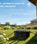 Large Outdoor Electrical Box Weatherproof IP54 Heavy Duty Extension Cord Cover Protect Outlets Plugs Sockets Timers Power Strips Black in garden setup.