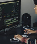 Person using desktop with 104-BT Compact Desktop Studio Monitors With Bluetooth, Black Finish, Pair Of 4.5-Inch Reference Speakers