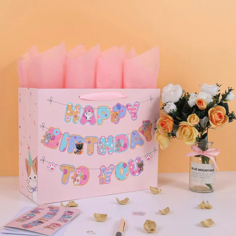 13 Inch Large Cat Birthday Gift Bag Set With Handles, Greeting Card, Pink Tissue Paper, Kitty Themed Stickers, Banner next to flowers