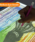 Using A2 Magnetic LED Light Pad for Diamond Painting on a colorful pattern, demonstrating precise application of beads.