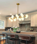 Mid Century Modern Sputnik Chandelier With 16 Lights Brushed Brass Arms And Frosted Milk Glass Shades For Kitchen Or Dining Room view above kitchen island.