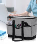 Nurse Tote Bag With Padded 15.6 Inch Laptop Sleeve For Work, gray shoulder bag with pockets, organized nursing tools in use.
