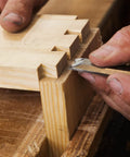 Using Built Tough 4 Piece Bench Chisel Set For Serious Woodworkers Carved From Top Shelf Chrome Vanadium Steel to refine wood joints.