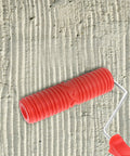 Top Tier Premium Grain Pattern Paint Roller With Slick Plastic Handle For Smoothing Over Bare Drywall and crafting embossed textures on a textured wall.