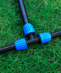 8 Pack Half Inch Drip Irrigation Tee Fittings with Barbed Nuts on grass