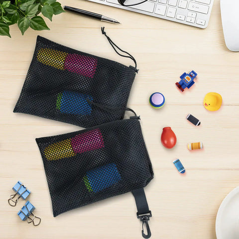 10 Pack Mesh Drawstring Bags With Clips Grab And Go Portable Nylon Storage Pouches containing toys on a desk