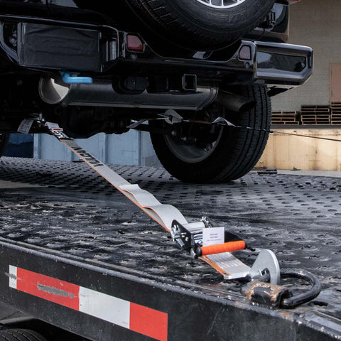 Complete Axle Strap Tie Down Kit With Snap Hook Ratchet Straps Silver Series Webbing securing vehicle on trailer