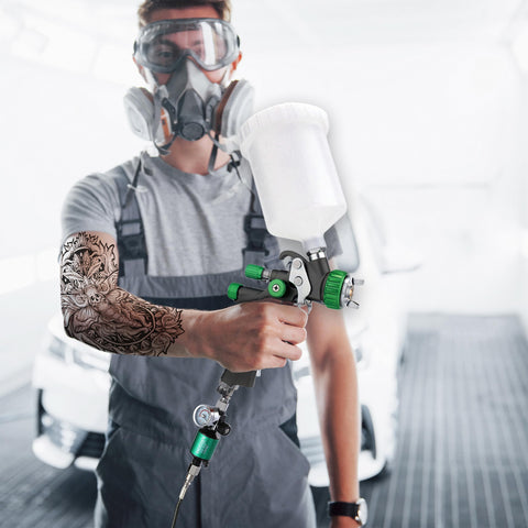 Person using spray gun attached to G1/4 Inch Inlet And Outlet Air Compressor Water Separator With Drain Valve And Pressure Regulator