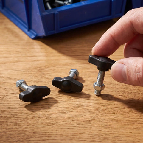 Dang Dependable M4 M5 M6 Tee Wing Bolt Knob Set, black plastic knobs and threaded screws for tripod mounts on wooden surface.