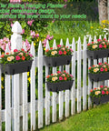 Get Your Garden Game On Point With This Set Of Two Deck Railing Planter Boxes That Clip Over Fence Rails Packed With Six Tough Plastic Flower Pots To Make Growing Herbs Veggies Or Blooms An Absolute Breeze For Chill Weekends And Easy Peasy Garden Vibes. Three-tier black rail planter with flowers on a white fence.