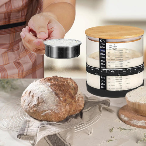 66 Oz Wide Mouth Sourdough Starter Jar Kit With Easy Read Ounce And ML Scale Lines For Real Date Marked Feeding Band Thermometer Sourdough Jar Scraper Cloth Cover And Bamboo Wood Lid Black next to fresh loaf and flour