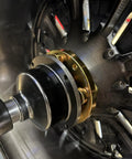 Grip Tight 40mm Shaft Wheel Balancer Adapter With Shop Grade Tire Balancer Clamp mounted on wheel for precise balancing.