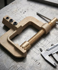 Top Notch Totority Welding Ground Clamp With Sturdy Spring And Electroplated Copper Earth Clip For Efficient Low Temp Rise Jobs At Shop Or In The Field on a workbench.