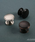 10 Pack Brushed Satin Nickel Round Cabinet Knobs One Point One Inch Diameter Solid Cabinet Hardware trio on fabric surface