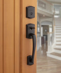 Prescott Front Door Lock Handle And Deadbolt Set, Exterior Handleset with Interior Reversible Lever, Venetian Bronze on wooden door