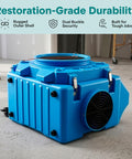 Beefed Up 3 Stage Filtration MERV 10 And HEPA Carbon Odor Removal Portable Air Purifier, blue, with rugged outer shell in a workshop.