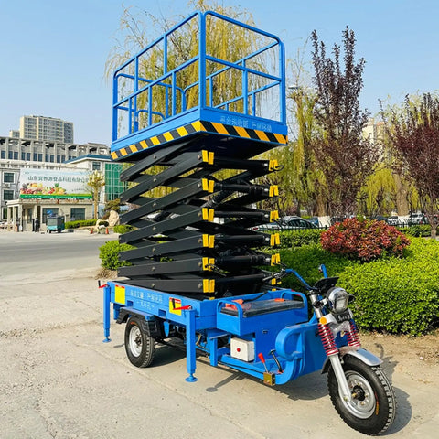 Heavy Duty Electric Hydraulic Scissor Lift Platform With 1000 Kg Capacity Mobile Aerial Work Table, blue, elevated, outdoor setting.