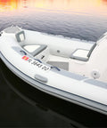 Marine Registration Plate Kit For Inflatable Boats And Ribs No Glue Needed 4 By 24 Inch ABS Mounting Boards With Zip Ties Saltwater Resistant Made In USA Pair displayed on a white inflatable boat in water