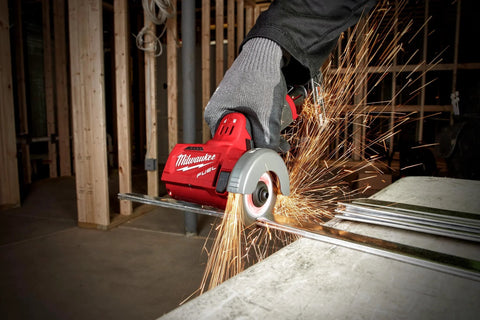 Milwaukee 12V cut-off tool, bare tool, side view cutting metal bar with sparks; red body, gray guard.