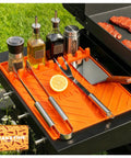 Silicone Grill Mats For Blackstone Griddle Accessories And Outdoor Cooking with kitchen tools and seasoning bottles.
