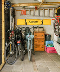 Garage with bicycles, tools, and storage; Portable Spill Containment Berm For Oil And Chemicals 4x4 Folding Duck Pond Tray visible