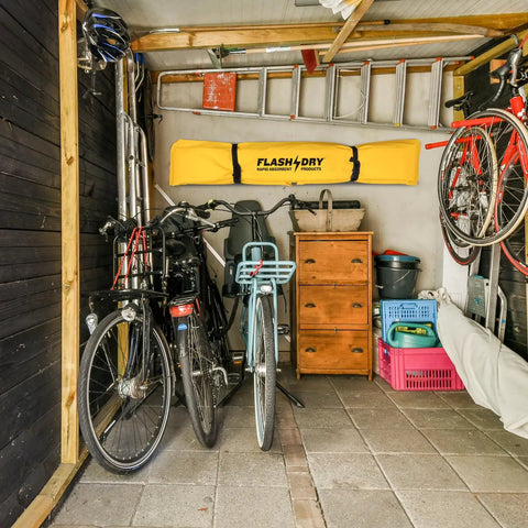 Garage with bicycles, tools, and storage; Portable Spill Containment Berm For Oil And Chemicals 4x4 Folding Duck Pond Tray visible