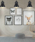 Room with 2 In 1 Plug In Or Hardwired Swing Arm Wall Light Sconce In Industrial Black Finish over framed animal artwork.