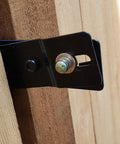 Lockable Post Mount Latch For Wood Gates And Doors Black Finish close-up on wood gate post with bolt attachment