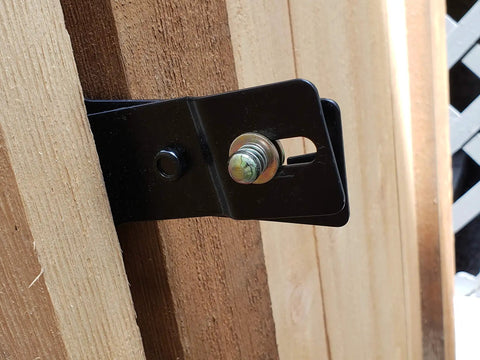 Lockable Post Mount Latch For Wood Gates And Doors Black Finish close-up on wood gate post with bolt attachment