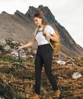 Woman hiking in Women's Go-To Hiking Cargo Pants With 6 Pockets Lightweight Water Resistant Quick-Dry 4-Way Stretch Black Large