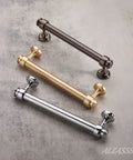 Three metal cabinet pulls in chrome, gold, and bronze, representing the 15 Pack Polished Chrome Cabinet Pulls 5 Inch Hole Center.