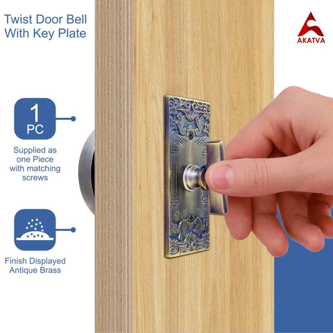 Hand twisting vintage Victorian twist bell with key plate mechanical doorbell on wooden door, antique brass chime for home.