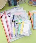 Mesh Zipper Pouch Set Of 8 Colorful Waterproof Storage Bags in different sizes for travel and home organization on green surface.