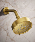 Purist Three Function Showerhead With 1.75 GPM Flow Vibrant Brushed Moderne Brass Finish mounted against marble wall
