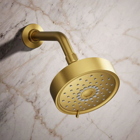 Purist Three Function Showerhead With 1.75 GPM Flow Vibrant Brushed Moderne Brass Finish mounted against marble wall