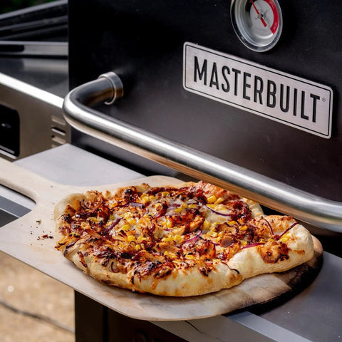 Gravity Series Outdoor Pizza Oven Accessory Insert With Ceramic Stone And Stainless Interior in use baking a pizza