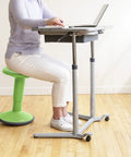 Person sitting on Sitwell Wobble Stool With Cushion Adjustable Height Active Seating For Movement Perfect For Class Or Home Grassy Green