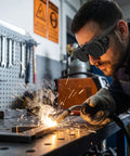 Badass Dual Lens Welding Safety Glasses With Dark Goggle Shield For Killer Arc Flash Blocking And Rock Solid All Day Workshop Comfort Built Tough For Hardcore Metal Working Crews, worn by a man welding.
