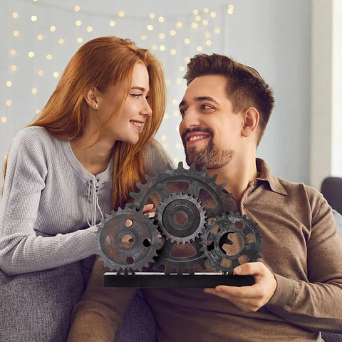 Novabright Vintage Copper Steampunk Gear Train Figurine For Desk Decor held by a smiling couple indoors