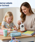 A mom and daughter use the Slick Mini Bluetooth Label Maker With Five Colorful Tapes And Smart LED Display for school projects.