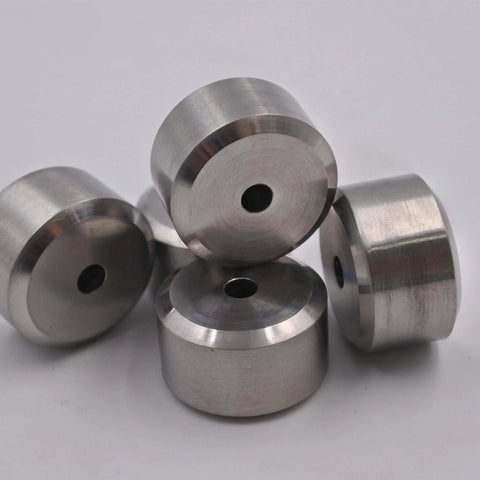Five stainless steel waterjet nozzle seats with central holes.