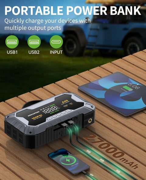 8000A Jump Starter with 160 PSI Air Compressor and 12V Power Bank charging devices on a table with USB ports visible.