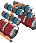 No Sweat Portable Wire Spool Rack And Cable Dispenser With Six Adjustable Steel Rods holding assorted cable spools in orange steel.