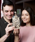 Couple holding Old Clock Tower 3D Puzzle Kit For Adults, Hands-On Wooden Mechanical Model With Moving Gears, Pendulum, Weathervane, And Clock Face, DIY Wood Building Kit, Brain-Building Mechanical Puzzle And Home Decor