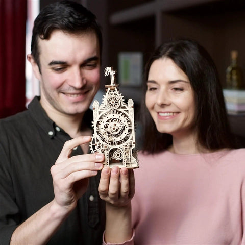 Couple holding Old Clock Tower 3D Puzzle Kit For Adults, Hands-On Wooden Mechanical Model With Moving Gears, Pendulum, Weathervane, And Clock Face, DIY Wood Building Kit, Brain-Building Mechanical Puzzle And Home Decor