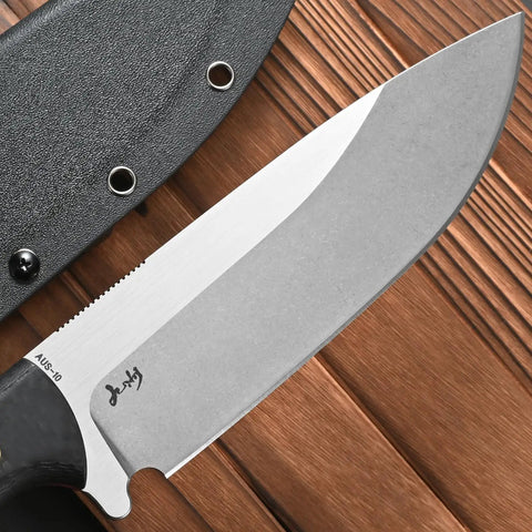 Close-up of Rugged AUS 10 Fixed Blade Knife With Carbon Fiber Handle and sheath on wooden background, showcasing the blade detail.